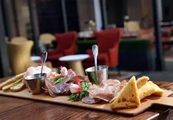 Charcuterie board with wild fennel sausage, Virginia ham, air-dried beef, Michigan cherry compote, whole-grain mustard and country toasts, from Kresge Court in the Detroit Institute of Arts.