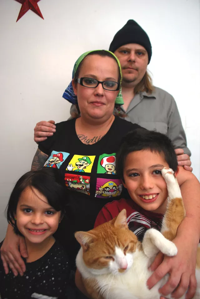 Christina Walsh and Danny Browning with Lyllie and Luther inside their apartment.