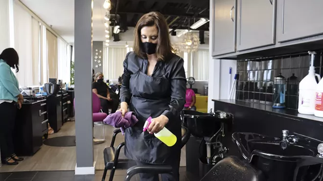 Gov. Gretchen Whitmer at Reflections Hair Salon in Grand Rapids, where she helped clean equipment.