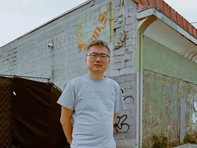 Curtis Chin stands outside his parents’ former Cass Corridor restaurant, Chung’s Cantonese Cuisine.