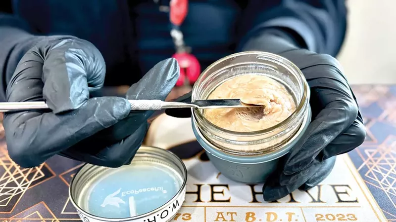 A budtender scoops out live rosin from the Hive’s unique deli.