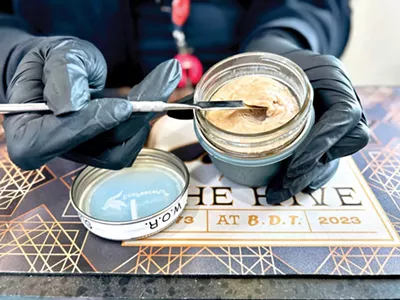 A budtender scoops out live rosin from the Hive’s unique deli.
