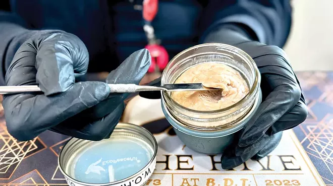 A budtender scoops out live rosin from the Hive’s unique deli.