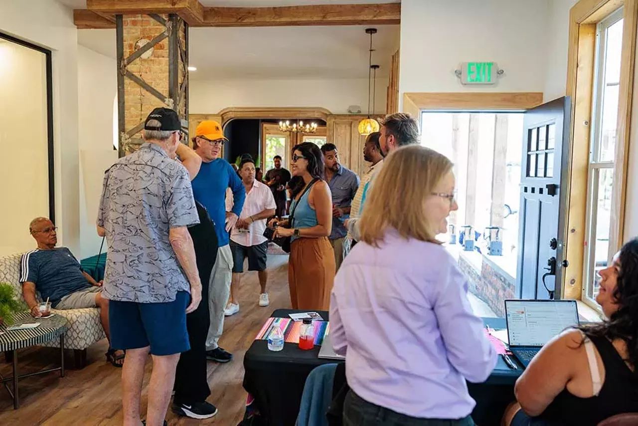 Attendees gather inside the Design Build Green Tech Hub during its grand opening event on September 14, 2024.