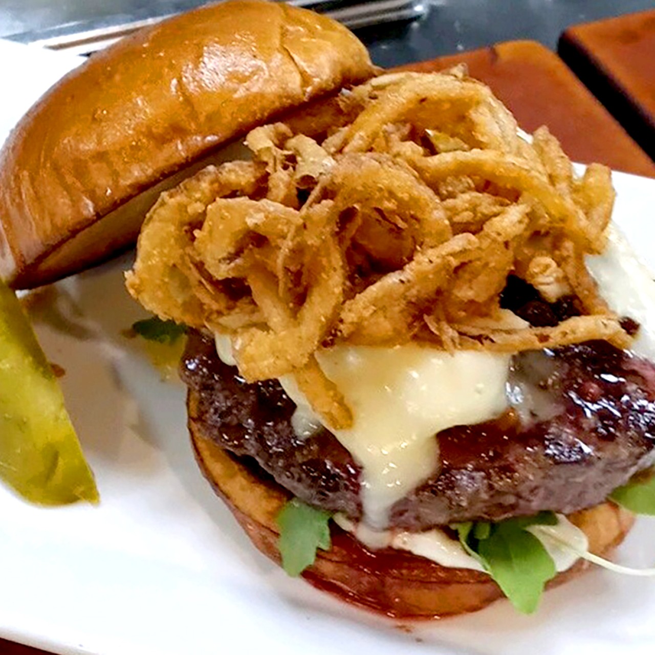Chef Paul Jackman's Jack Daniel&#146;s Rye Prime Burger
A grilled custom blend of beef: ground short rib, brisket, and chuck, Jack Daniel&#146;s Rye hickory-smoked bacon jam, double cream brie cheese, fresh arugula, toasted caraway seed truffle aioli, crisp cajun rye onion straws, rye infused brioche bun.
Ingredients:
- Burger: &frac12; pound Certified Angus Custom Blend Patty
- 1 Caraway seed infused brioche bun 4.5-inch
- &frac14; cup fresh arugula
- 4 oz. of sliced double cream brie cheese
- 2 oz. toasted caraway seed truffle aioli with roasted garlic
- 2 oz. crisp onion straws	
- 3 oz. Jack Daniel's Rye bacon jam
Assembly:
Grill burger to desired temperature I recommend 120 degrees 
Spread on 3 oz. of Jack Daniel&#146;s Rye bacon jam
Cover with 4 oz double cream brie and broil until bubbly
Toast Rye bun on a flat top grill until crispy
Place bun on cutting board and apply caraway aioli on bottom bun
Place fresh arugula on bottom bun
Place burger patty with jam and cheese on arugula
Top with onion straws
Enjoy with Jack Daniel&#146;s Rye!
