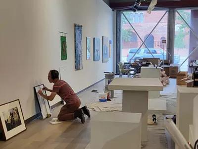 A worker puts the finishing touches on the Detroit Artists Market ahead of its first exhibition since it was remodeled.