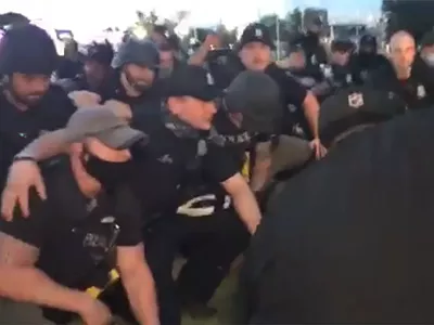 Image: Detroit Police kneeled for the cameras minutes after arresting about 100 peaceful protesters