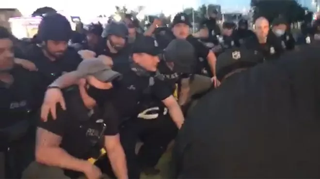 Image: Detroit Police kneeled for the cameras minutes after arresting about 100 peaceful protesters