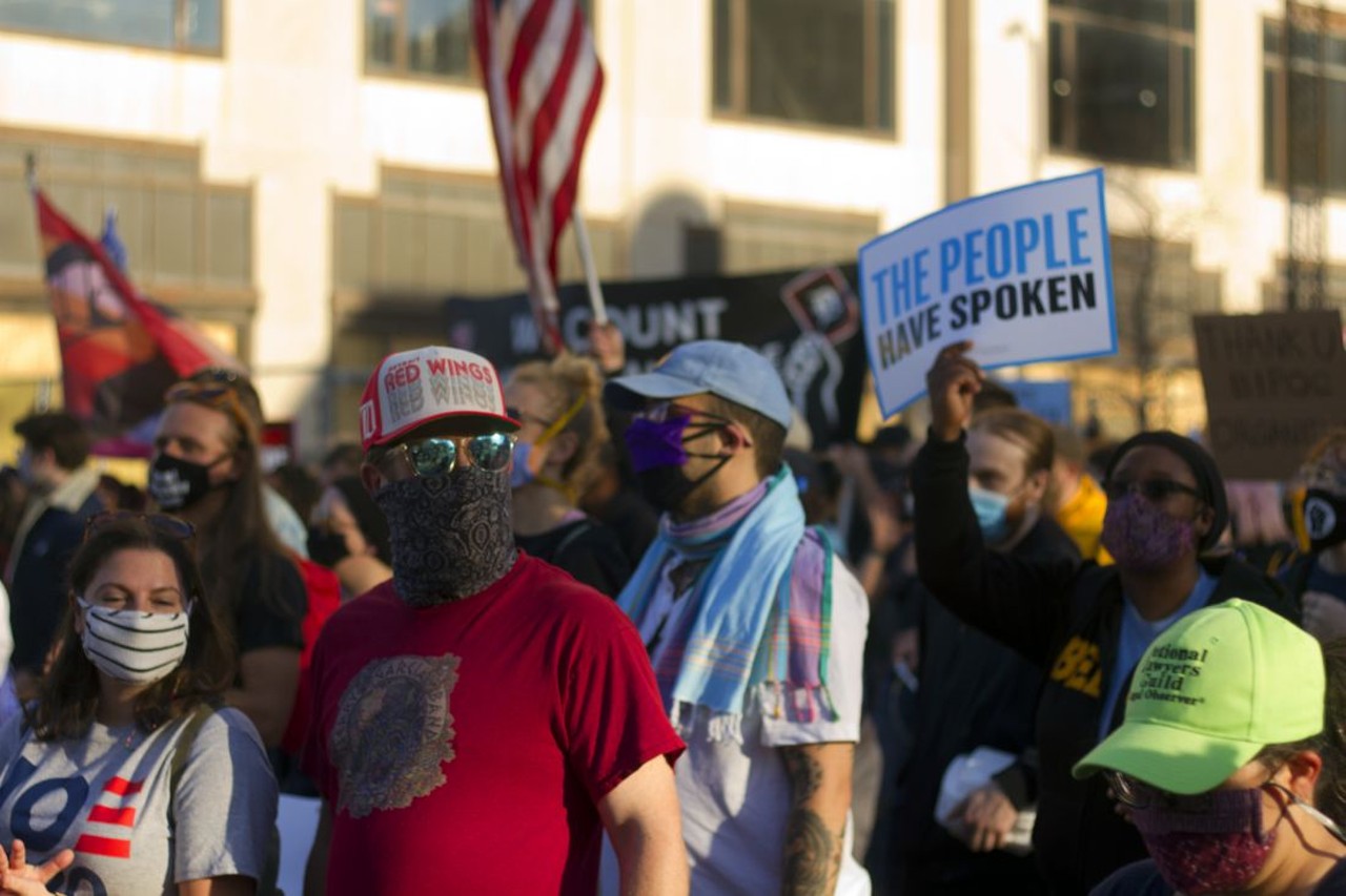 Detroiters celebrate the defeat of President Donald Trump by marching in the street