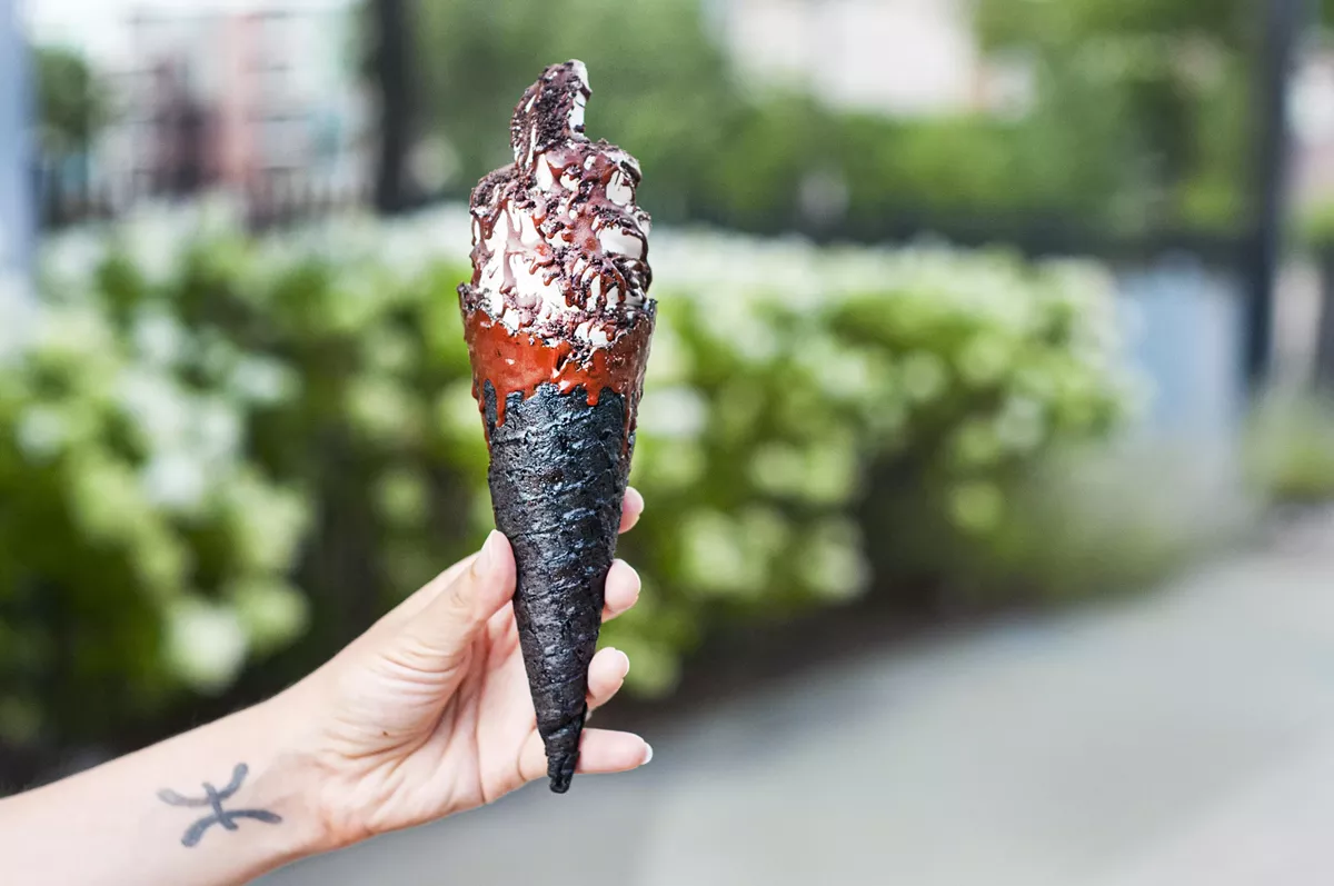 Image: The Sweet Creem, with dark chocolate magic shell in a dark chocolate dipped gluten-free and vegan handmade waffle cone.