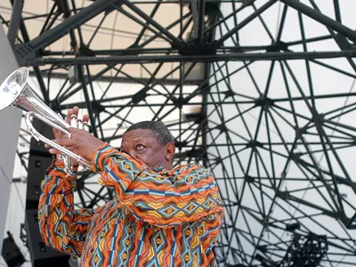 Hugh Masekela, of South Africa, warms up before performing at the Concert of Colors Saturday, July 20, 2002, at Chene Park in Detroit.