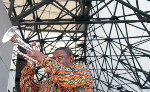 Hugh Masekela, of South Africa, warms up before performing at the Concert of Colors Saturday, July 20, 2002, at Chene Park in Detroit.