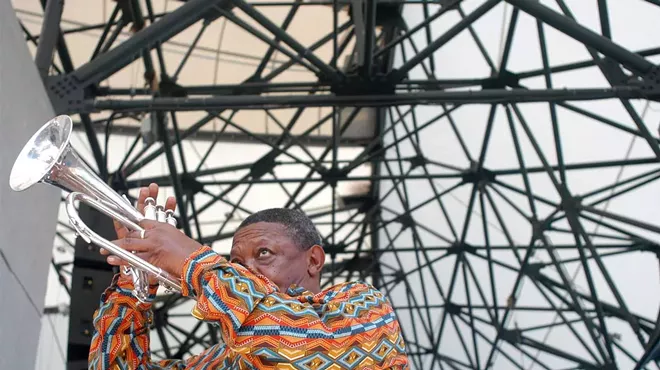 Hugh Masekela, of South Africa, warms up before performing at the Concert of Colors Saturday, July 20, 2002, at Chene Park in Detroit.