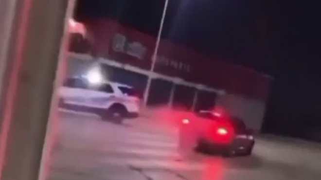 A Dodge Charger does doughnuts around a DPD car.