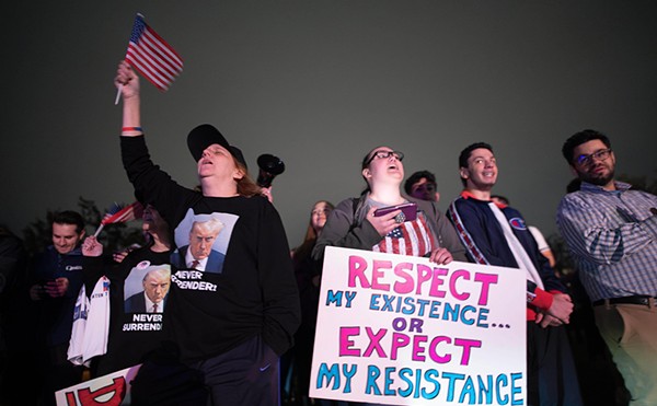 Supporters react as they listen to Donald Trump’s speech live on the radio outside of Drake Enterprises, an automotive supplier in Clinton Township in Macomb County.