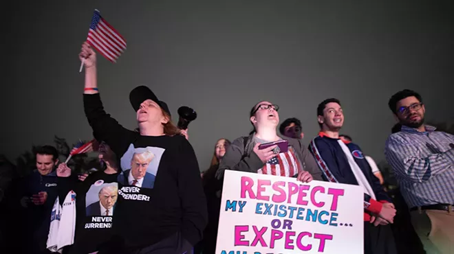 Supporters react as they listen to Donald Trump’s speech live on the radio outside of Drake Enterprises, an automotive supplier in Clinton Township in Macomb County.