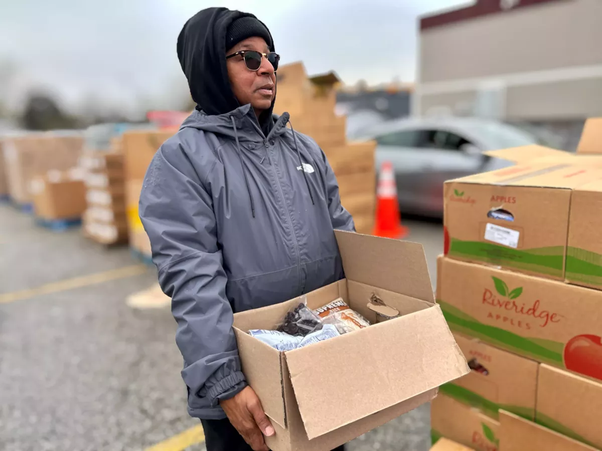 Image: Mark Craighead, founder of Safe Place Transition Center, hands out food to lower-income families in Mount Clemens.