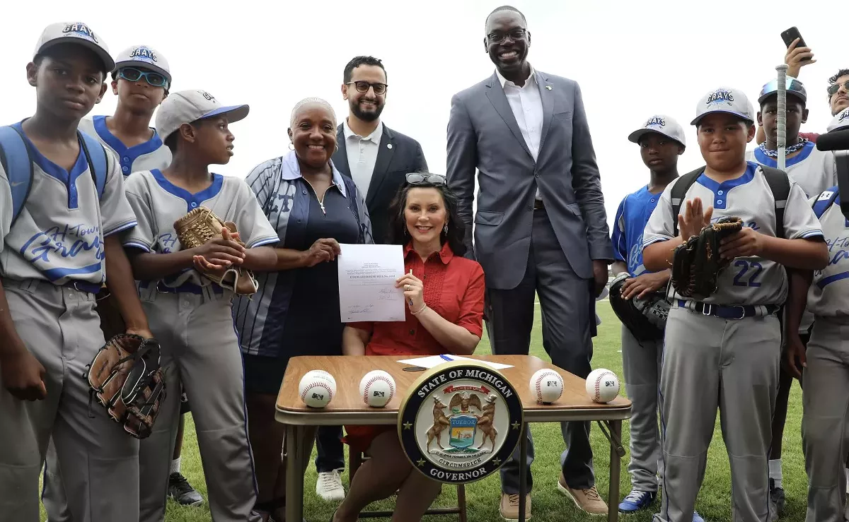 Image: Gov. Gretchen Whitmer signs a bill at Historic Hamtramck Stadium recognizing May 2 as Negro Leagues Day in Michigan.