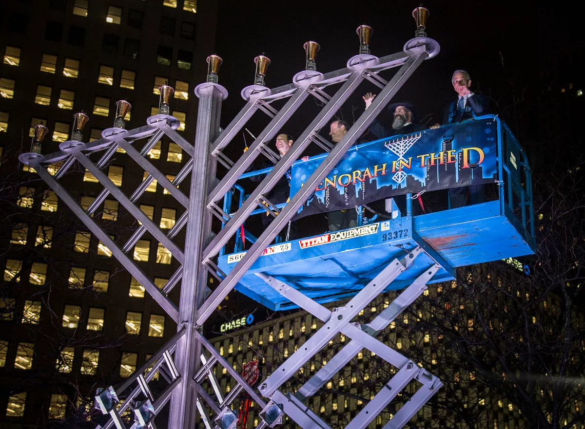 Image: Rabbi Kasriel Shemtov, second from right, leads the Menorah in the D festivities.