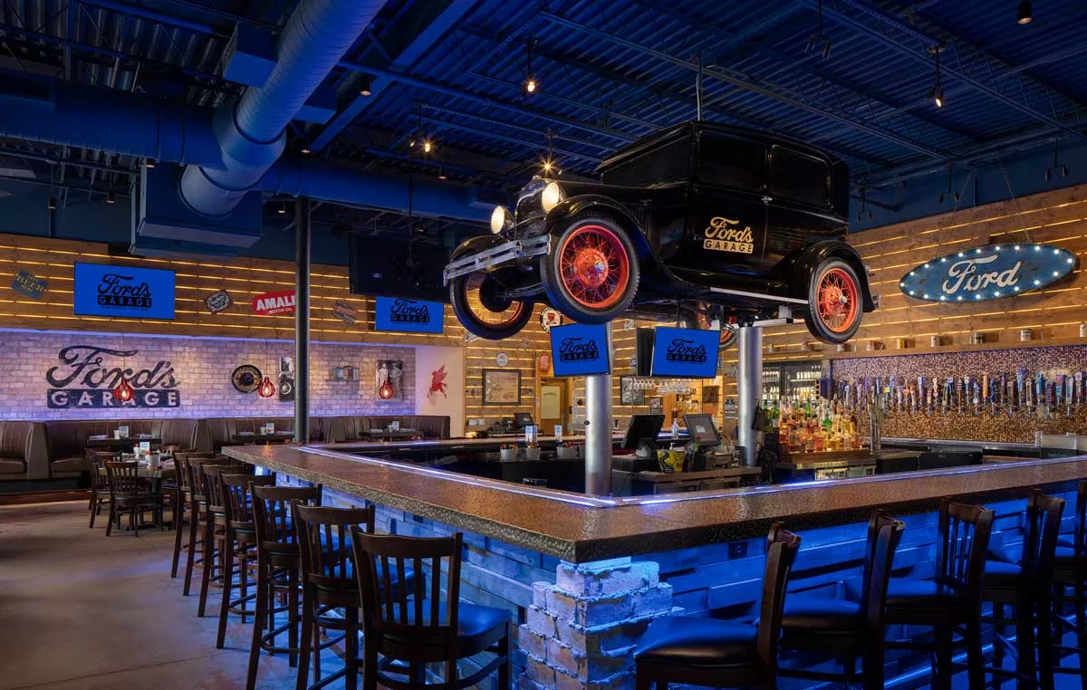 Image: Ford’s Garage boasts an automotive theme complete with a vintage car suspended over its bar.