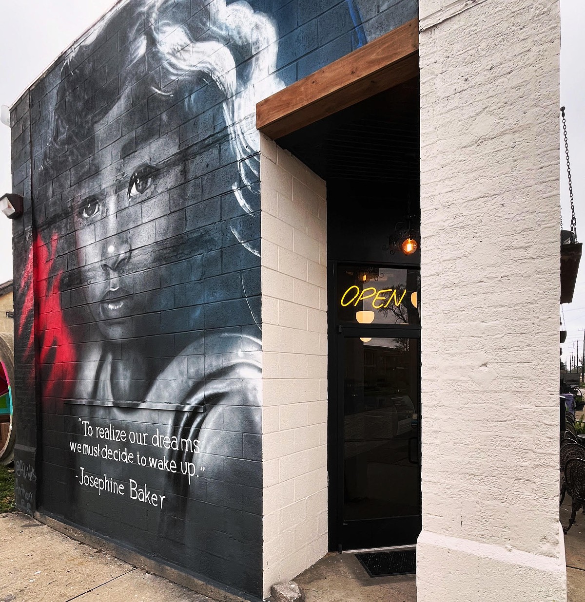 The outside of Cafe Noir features a mural of young Josephine Baker.