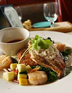 Grilled Chicken and Scallops with honey coconut butter glaze, sweet potato cake, sauteed spinach and red mole sauce. - MT Photo: Rob Widdis