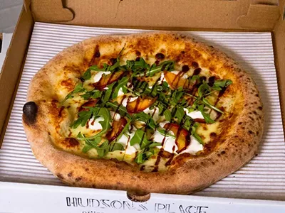 A seasonal Peaches N’ Burrata pizza from Hudson’s Place.