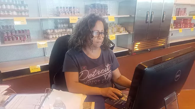 Rev. Roslyn Bouier sits at her desk inside the food pantry. The executive director says demand is growing for the pantry’s services.