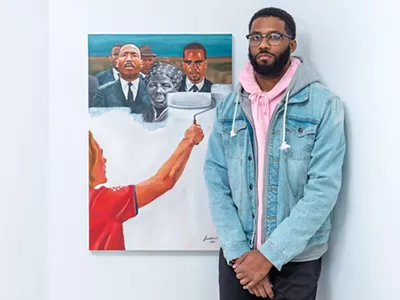 Jonathan Harris with his "Critical Race Theory" painting.
