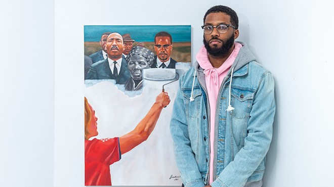 Jonathan Harris with his "Critical Race Theory" painting.
