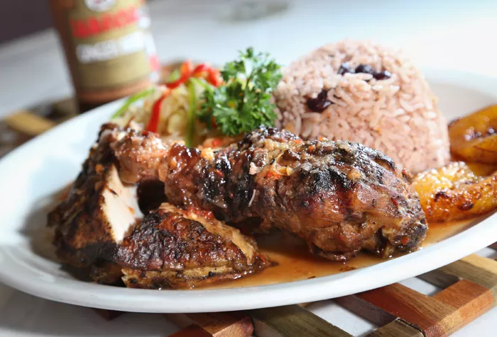 Jerk Chicken with sides of cabbage, peas and rice, and plantains from Jamaican Paradise in Oak Park. - Photo by Rob Widdis.