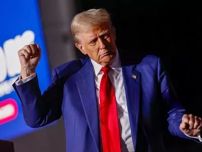 President-elect Donald Trump dances on stage during a campaign rally at the Suburban Collection Showplace in Novi on Oct. 26, 2024.