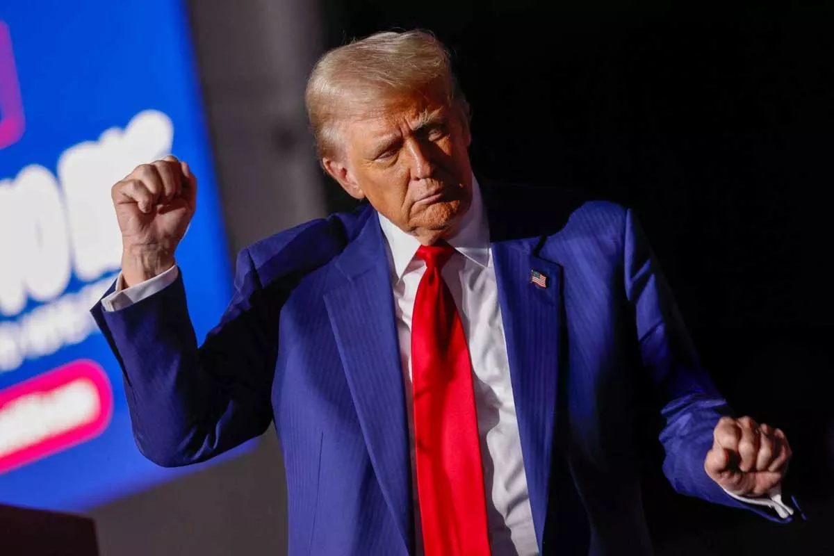 Image: President-elect Donald Trump dances on stage during a campaign rally at the Suburban Collection Showplace in Novi on Oct. 26, 2024.
