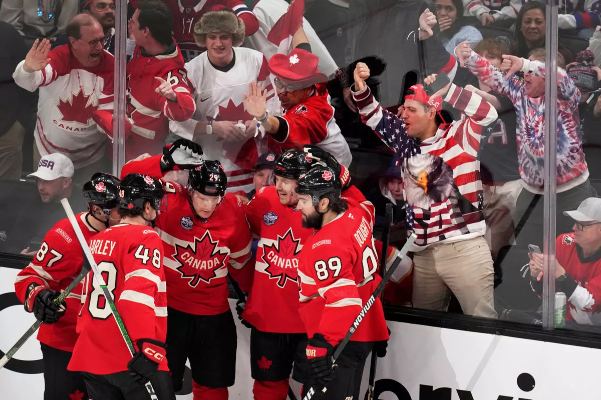 Image: Canada players celebrate after a goal by Nathan MacKinnon during the first period of the 4 Nations Face-Off championship hockey game against the United States in Boston.