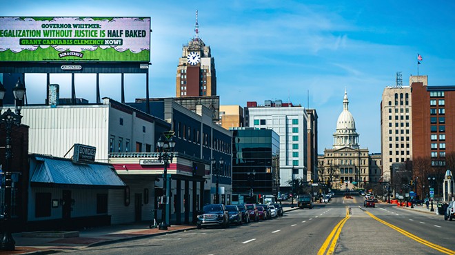 “Governor Whitmer: legalization without justice is half baked. Grant cannabis clemency now!” a billboard near the Michigan State Capitol reads.