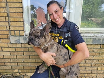 Melanie Fulkerson, an animal control investigator for the city of Detroit, holds Leo after rescuing him.