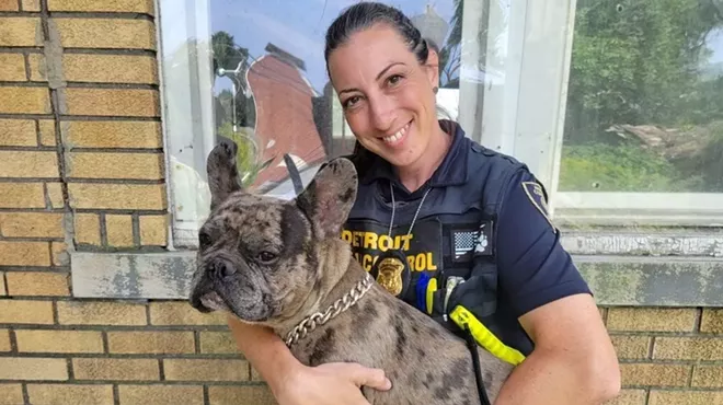 Melanie Fulkerson, an animal control investigator for the city of Detroit, holds Leo after rescuing him.