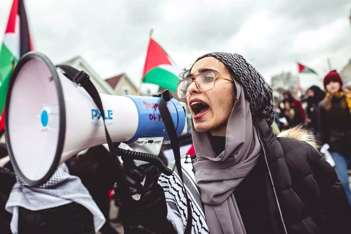 Image: A young woman speaks at an antiwar protest in Hamtramck.
