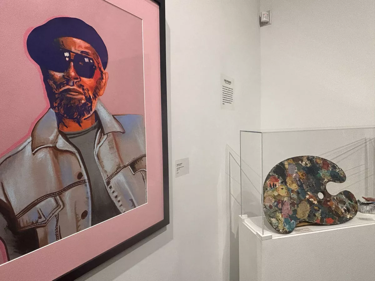 Image: A portrait of Harold Neil by Ijania Cortez next to Harold Neal’s palette.