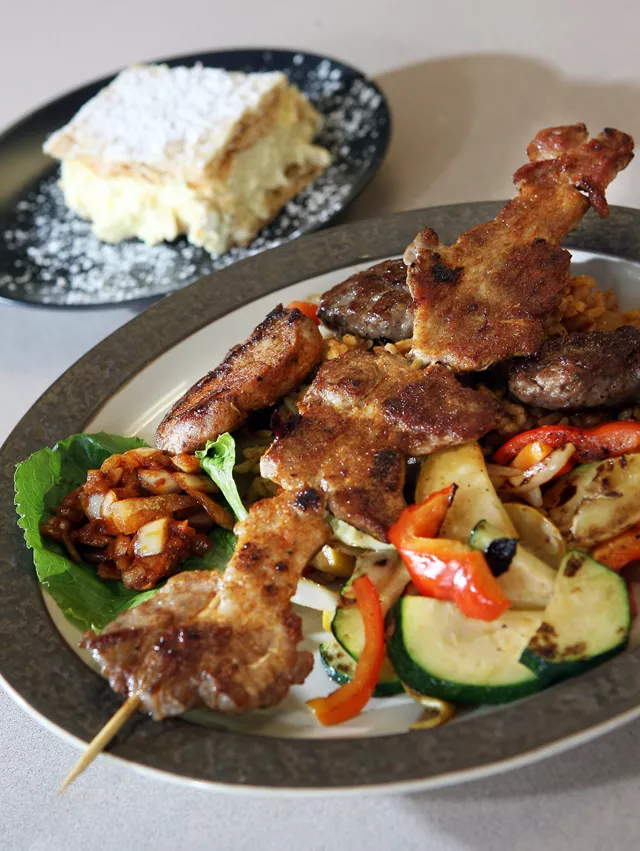 Macedonian Mix Grill: Pork skewer, tenderloin and balkan burger with mixed vegetables and djuvech rice (front), kreamish (rear left), and apple strudel (rear right) from Ellie's in Berkley.