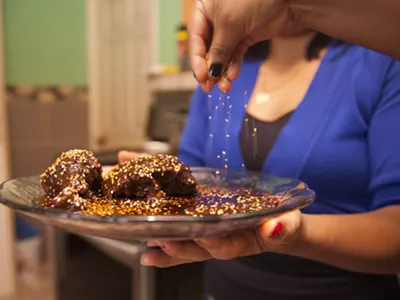Mariana Valdez and co-chefs place the finishing touch on their mole recipe.