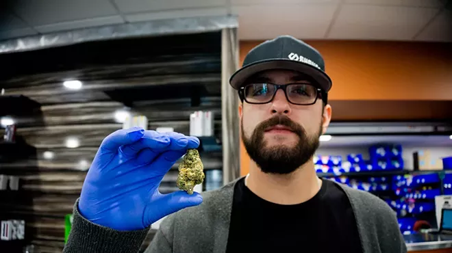 An employee shows off a nug at Hazel Park's dispensary Shango.