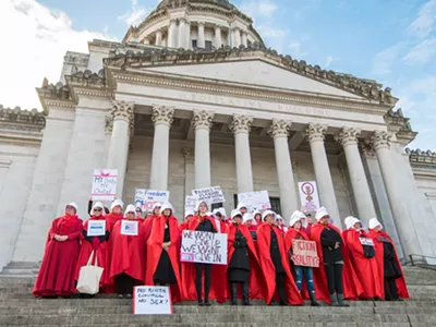 Abortion rights activists dress up as characters from The Handmaid's Tale at a protest.