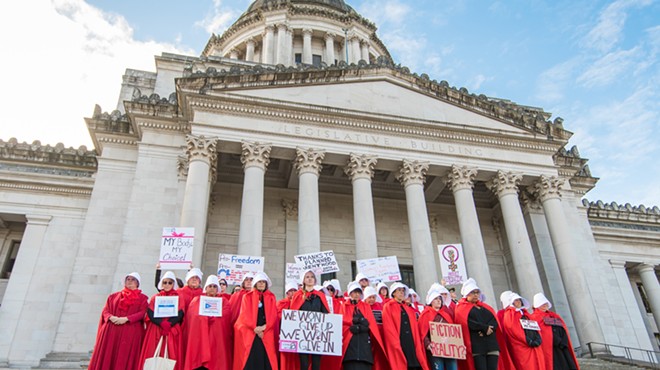 Abortion rights activists dress up as characters from The Handmaid's Tale at a protest.