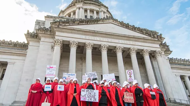 Abortion rights activists dress up as characters from The Handmaid's Tale at a protest.