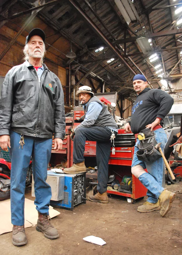 Minister Allan, Mechanic Greg and Carpenter Jeff inside their home at the Packard Plant. - Detroitblogger John