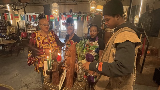 Mama Nandi (far left) and members of the Alnur African Dance group gather on the fifth day of Kwanzaa at Nandi's Knowledge Cafe.