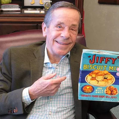 Jiffy Mix "Howdy Holmes with a vintage box of Jiffy Biscuit Mix (circa 1930). Mable White Holmes changed the baking world in 1930 with her paper bag of premixed biscuit ingredients presented to a widowed dad. All he had to do was add liquid. Almost a century later, people still create delicious baked goods “in a jiffy.”"