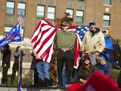 Michael Joseph Foy draped in an American flag at a pro-Trump rally in Detroit in November.