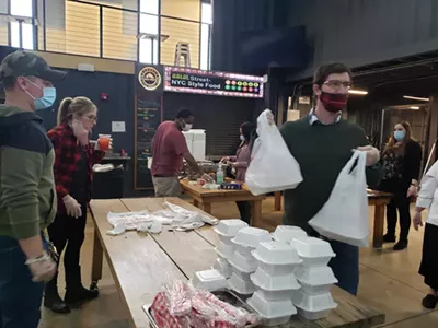 Volunteers help give away chef-made meals for the needy at the Detroit Shipping Co. in 2020.